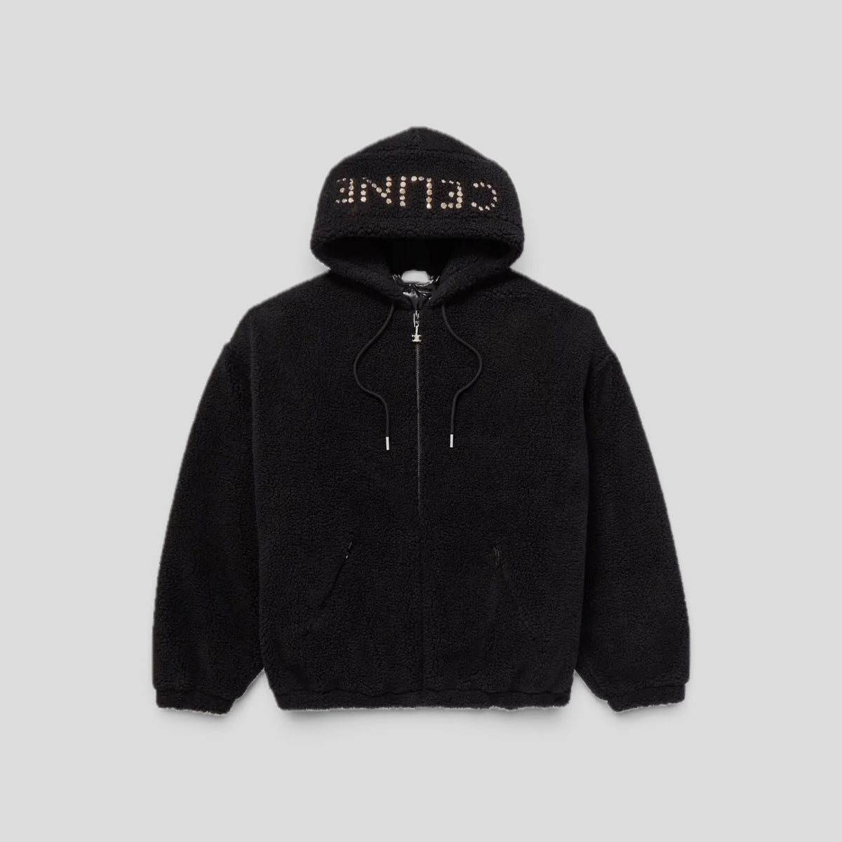 CLB XXIII black fleece zip-up hoodie featuring a studded Celine logo on the hood and a drawstring closure.