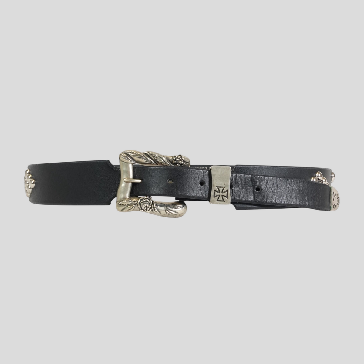 CLB XXIII Enfants Riches Déprimés black leather belt featuring a silver floral buckle and iron cross hardware.