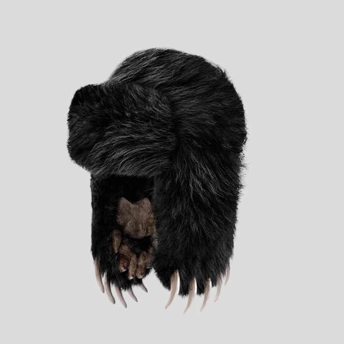 CLB XXIII Bravest Studios black faux fur trapper hat featuring realistic bear claws on the side flaps.
