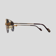 CLB XXIII gently used Cartier glasses featuring a gold titanium frame and dark temple tips in a side profile view.