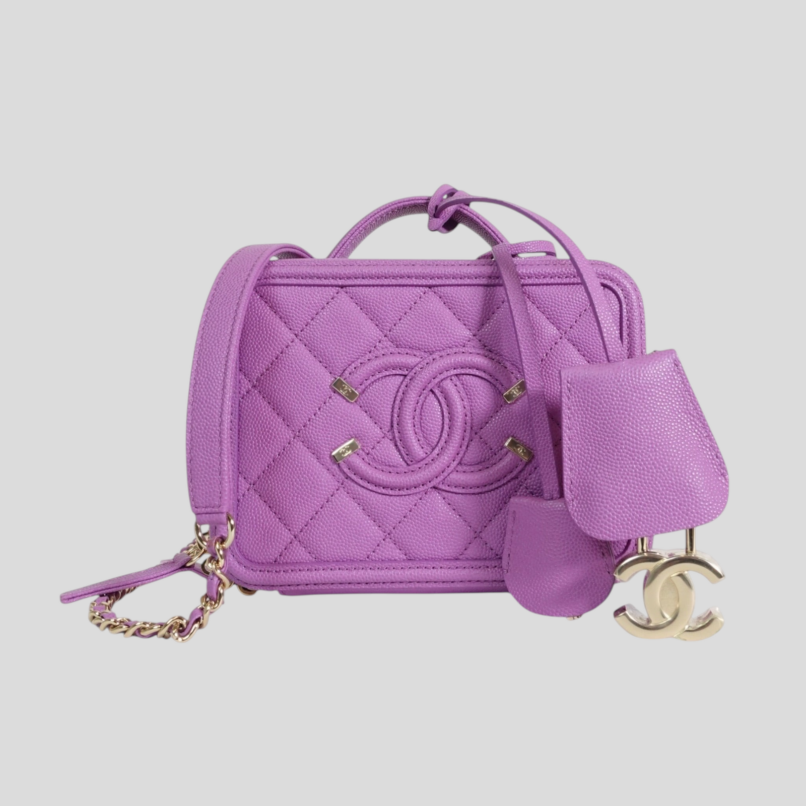 CLB XXIII Chanel Caviar quilted purple vanity case with CC logo, gold hardware, and matching lock and key charm.