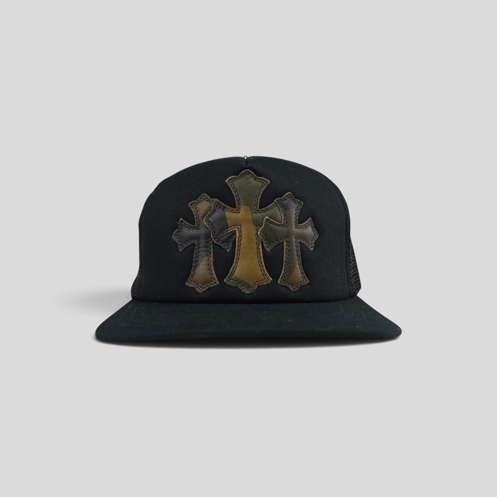 CLB XXIII Chrome Hearts black trucker hat featuring three leather camo cross patches on the front panel