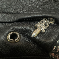 CLB XXIII Chrome Hearts black leather bean bag chair detail featuring a signature sterling silver dagger zipper pull