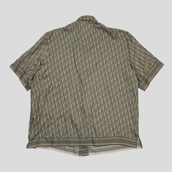 CLB XXIII Dior Oblique green silk button-up shirt featuring the iconic monogram pattern and striped hem detail