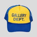 CLB XXIII GALLERY DEPT. trucker hat in blue and yellow with a mesh back and bold front logo print.