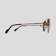 CLB XXIII gently used gold titanium Cartier glasses shown from a side profile view