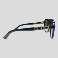 CLB XXIII Gucci navigator sunglasses with black frames and gold logo detail on the side temple