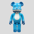 CLB XXIII 1000% Bearbrick Kaws Chomper figure in blue, white, and black with iconic X eyes and wide toothy grin.