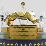 CLB XXIII Louis Vuitton holiday ornament set featuring a gold metallic carousel tiger on a navy blue leather base.