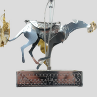 CLB XXIII Louis Vuitton holiday ornament featuring a metallic silver greyhound carousel figure with monogram base