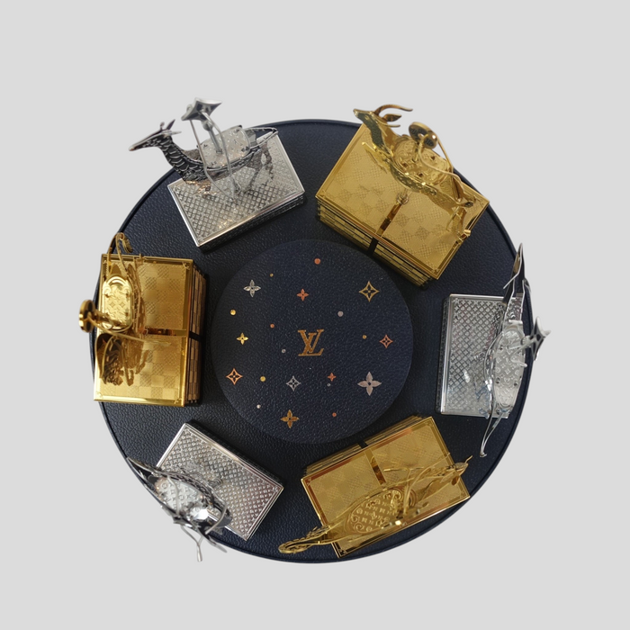 CLB XXIII Louis Vuitton holiday ornament gift set featuring gold and silver metallic animal figures on a round base