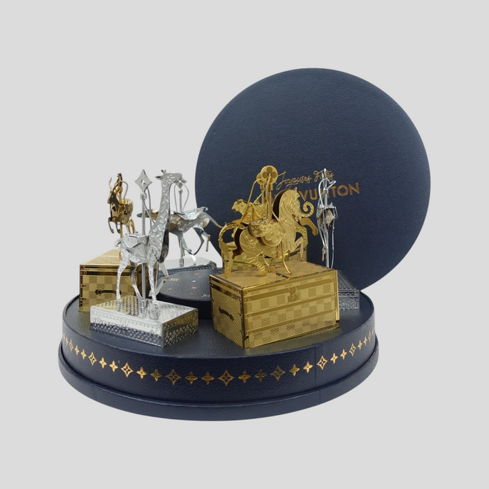 CLB XXIII Louis Vuitton holiday ornament gift set featuring metallic gold and silver animal carousel figures on trunks