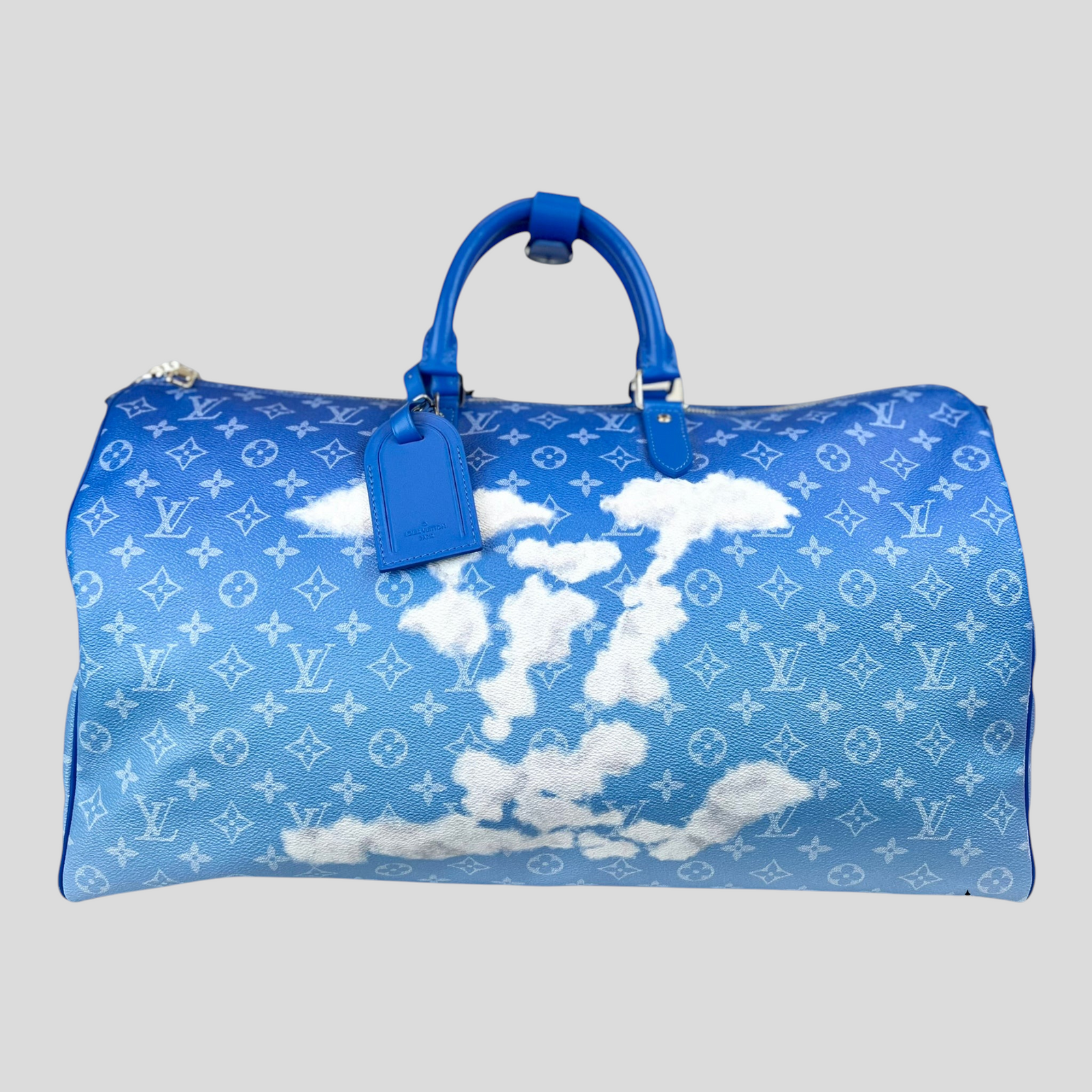 CLB XXIII Louis Vuitton Keepall Bandouliere 50 travel bag in blue Monogram canvas with white cloud print and handles.