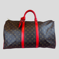 CLB XXIII Louis Vuitton Keepall Bandouliere 50 travel bag in brown monogram canvas with vibrant red leather trim