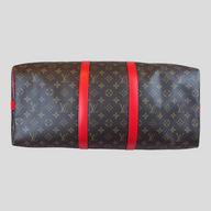 CLB XXIII Louis Vuitton Keepall Bandouliere 50 travel bag in iconic brown monogram canvas with vibrant coquelicot red trim.