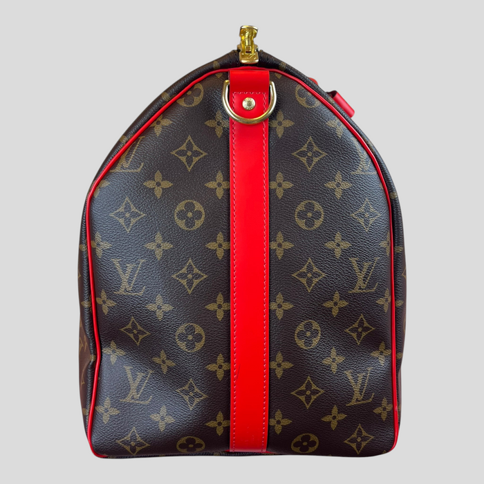 CLB XXIII Louis Vuitton Keepall Bandouliere 50 in brown monogram canvas with vibrant coquelicot red leather trim