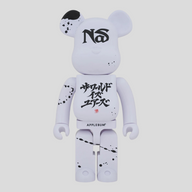 CLB XXIII 1000% Bearbrick Nas x Applebum collectible figure in white with black paint splatter and graphic details.