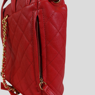 CLB XXIII red Chanel Caviar leather Filigree backpack featuring quilted texture, gold chain strap, and side zipper.