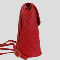 CLB XXIII red Chanel Caviar leather Filigree backpack with quilted texture and gold chain straps, side view.