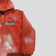 CLB XXIII red patchwork Carhartt work jacket with distressed paint splatter finish and Blind Love graphic patches.