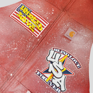 CLB XXIII red patchwork Carhartt work jacket featuring distressed paint splatter and Blind Love USA graphic patches.
