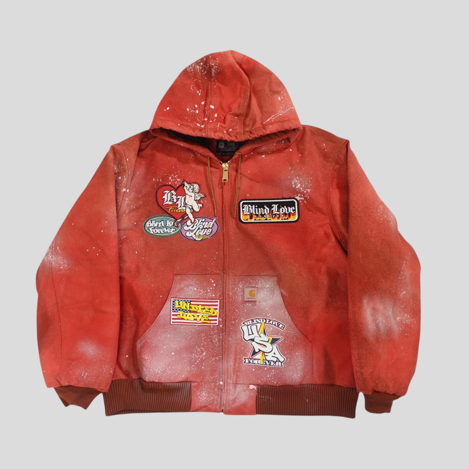 CLB XXIII red Carhartt work jacket with patchwork designs, distressed paint splatter, and a hooded zip-up front.