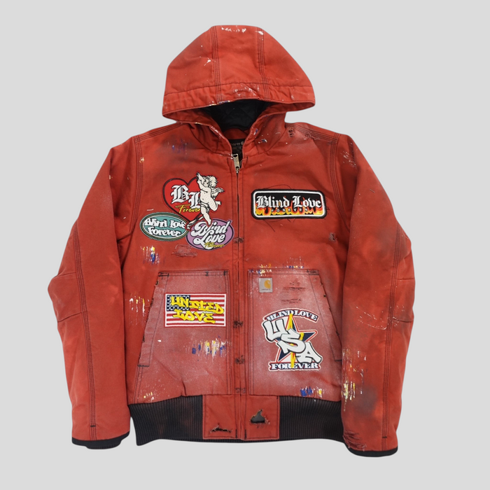 CLB XXIII red Carhartt work jacket featuring patchwork designs, distressed paint splatters, and a hooded silhouette.
