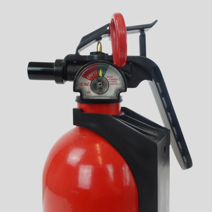 CLB XXIII Supreme fire extinguisher in red with black handle and pressure gauge, showing minor surface wear.