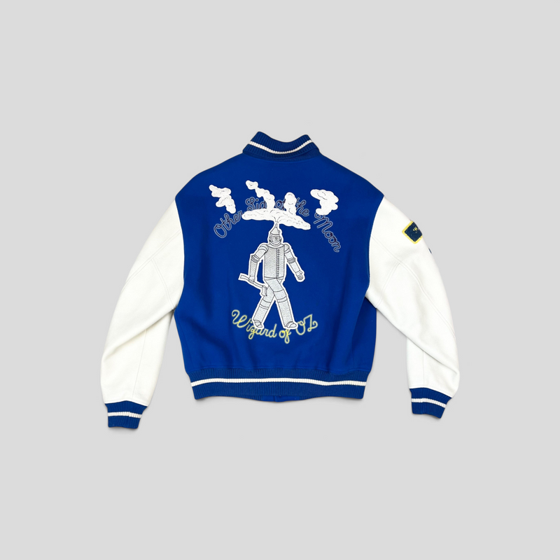 CLB XXIII blue and white varsity jacket featuring a Wizard of Oz Tin Man embroidery on the back