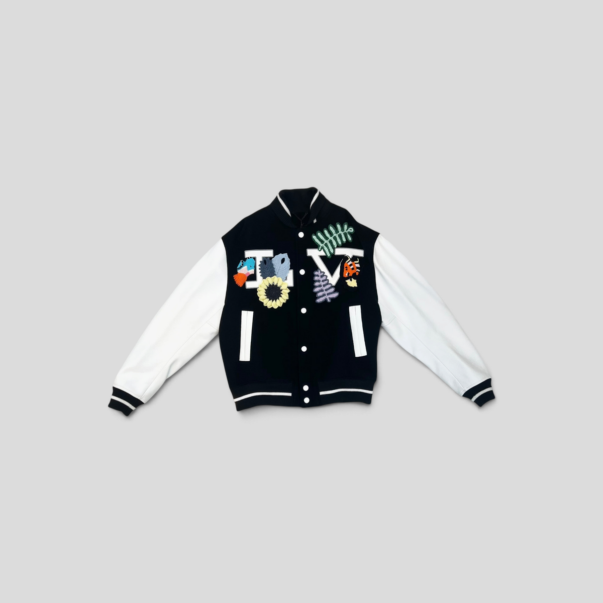 CLB XXIII Louis Vuitton varsity jacket in black wool and white cowhide leather with colorful crochet floral patches.